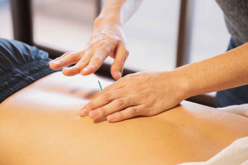 a woman getting a back massage at a spa.