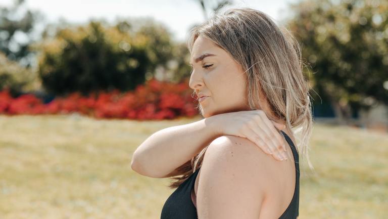 a woman with her arm around her neck.